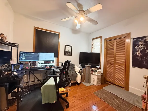 a view of a workspace with furniture and a flat screen tv