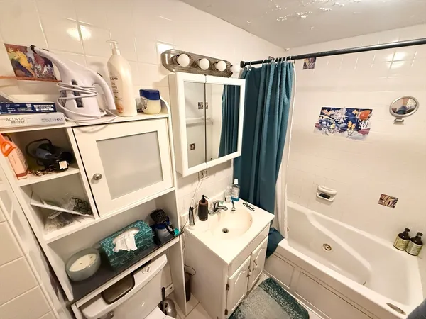 a bathroom with a bathtub and a sink