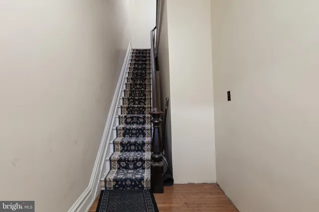 a living room with furniture rug and a window