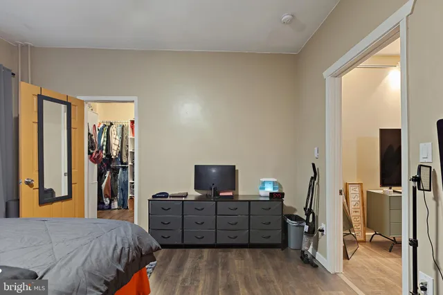 a view of walk in closet with clothes and shoes