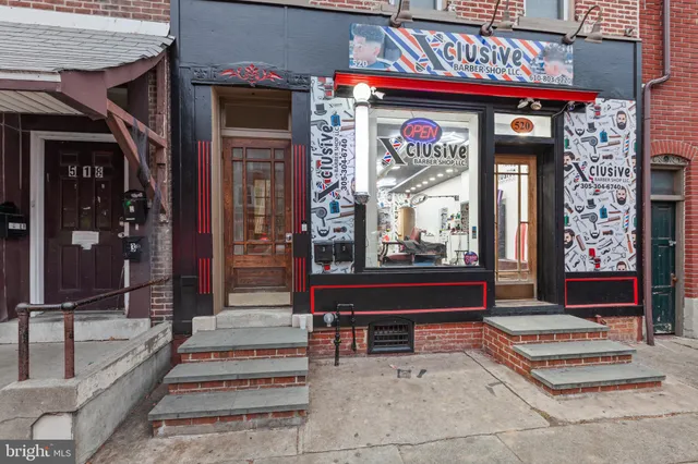 a front view of a building with outdoor seating