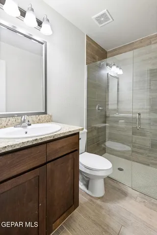 a bathroom with a granite countertop sink a toilet and bathtub