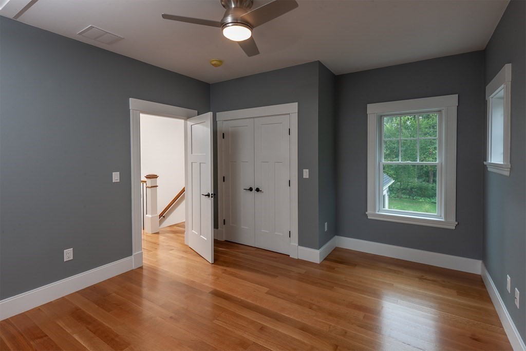 40 Rocky Hill Road Andover, MA 01810 - Photo 31 of 41 an empty room with wooden floor and a window