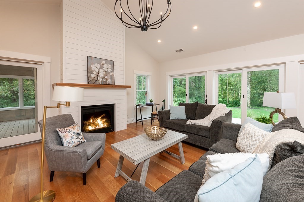 40 Rocky Hill Road Andover, MA 01810 - Photo 10 of 41 a living room with furniture a large window and a fireplace