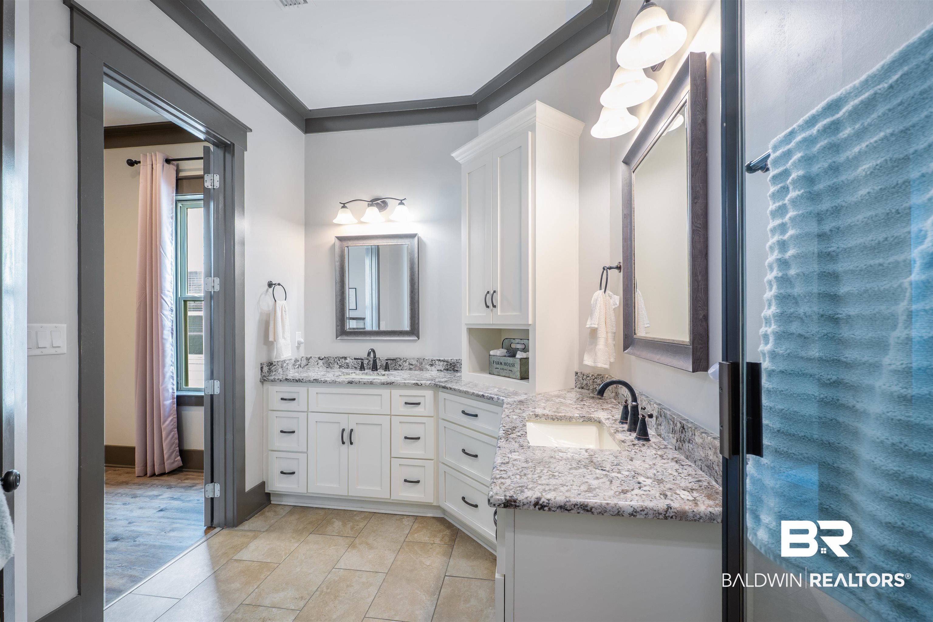 1119 Pink Poppy Lane Foley, AL 36535 - Photo 14 of 38 Primary bathroom suite with two vanities, ornamental molding, and light tile patterned floors
