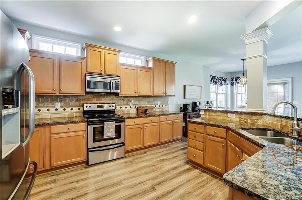 3284 Richard's Crossing Fort Mill, SC 29708 - Photo 14 of 43 a kitchen with stainless steel appliances granite countertop a stove a sink and a microwave