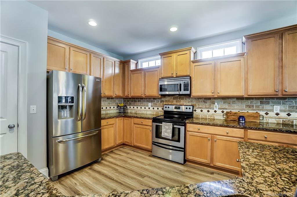 3284 Richard's Crossing Fort Mill, SC 29708 - Photo 16 of 43 a kitchen with stainless steel appliances granite countertop a refrigerator stove and microwave