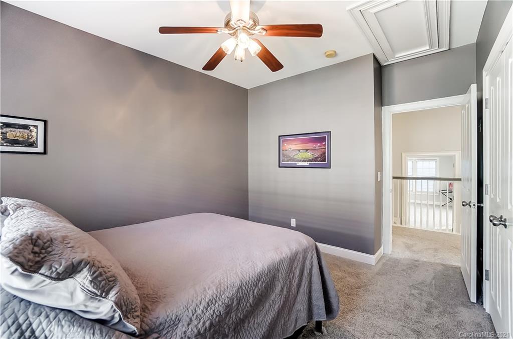3284 Richard's Crossing Fort Mill, SC 29708 - Photo 33 of 43 a bedroom with a bed and a chandelier