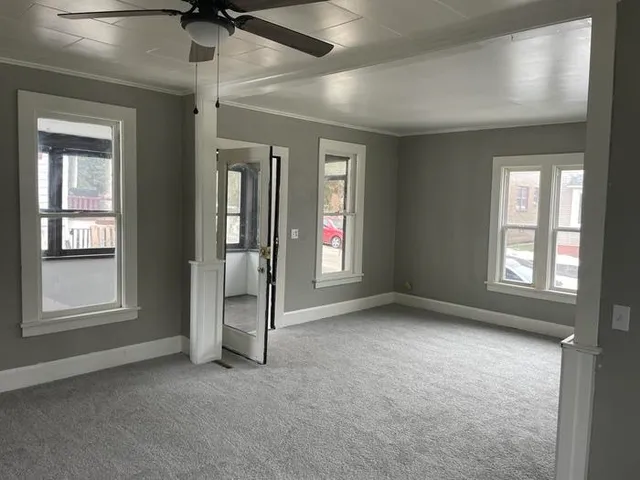 an empty room with windows and closet