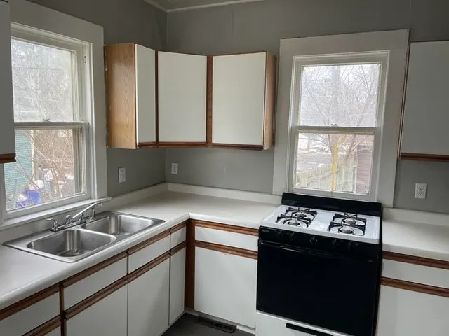 a kitchen with a sink and a window