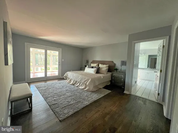 a bedroom with a large bed and a window