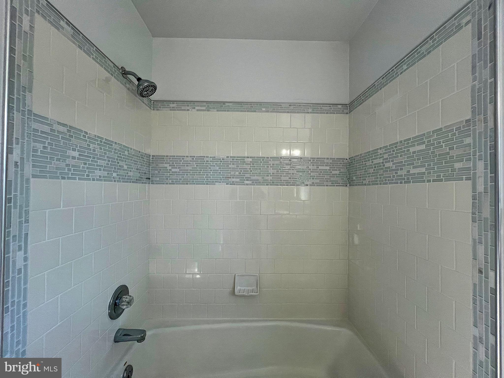 5629 Gunner Run Road Churchton, MD 20733 - Photo 29 of 51 a bathroom with a shower and a bathtub