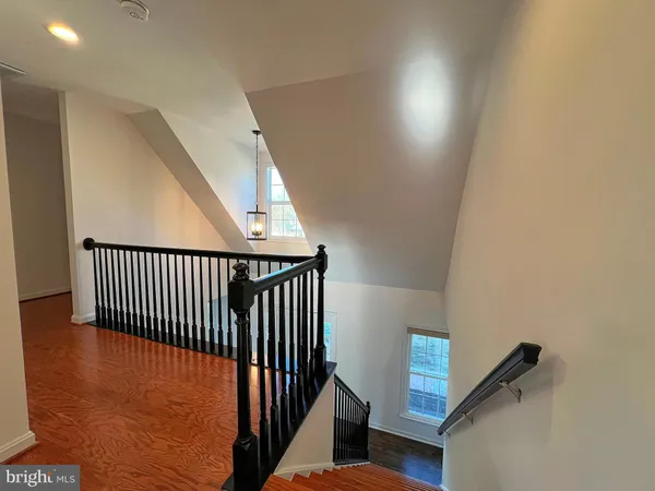 a view of staircase with railing and a window