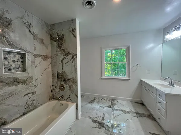 a bathroom with a bathtub and a sink