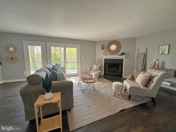 a living room with furniture fireplace and a large window