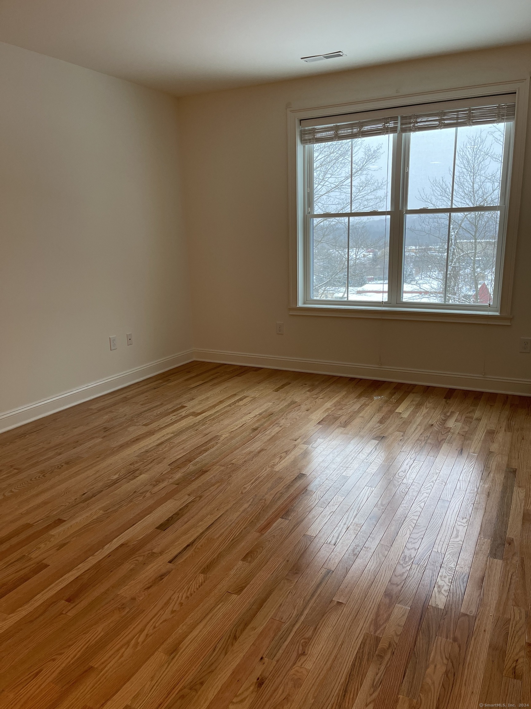 35 Old Quarry Road, Unit C8 Ridgefield, CT 06877 - Photo 6 of 15 a view of an empty room with wooden floor and a window