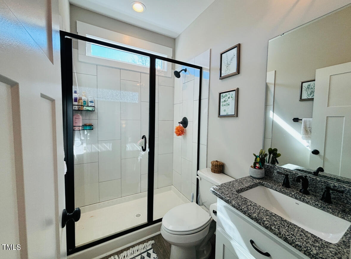 2510 Nc 55 Dunn, NC 28334 - Photo 11 of 13 a bathroom with a granite countertop sink toilet and shower