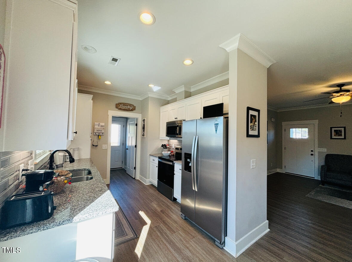 2510 Nc 55 Dunn, NC 28334 - Photo 5 of 13 a kitchen with stainless steel appliances granite countertop a refrigerator and a sink