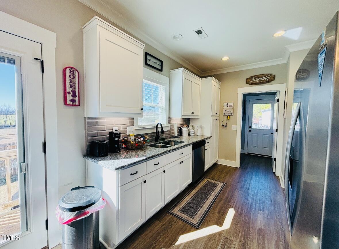 2510 Nc 55 Dunn, NC 28334 - Photo 6 of 13 a kitchen with stainless steel appliances a sink and a refrigerator
