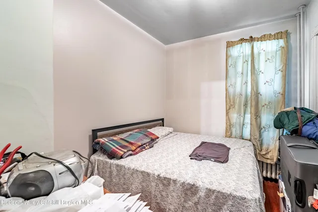 a bedroom with a bed and ceiling fan