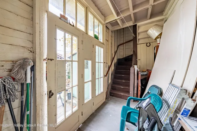 a view of an entryway with wooden floor and stairs