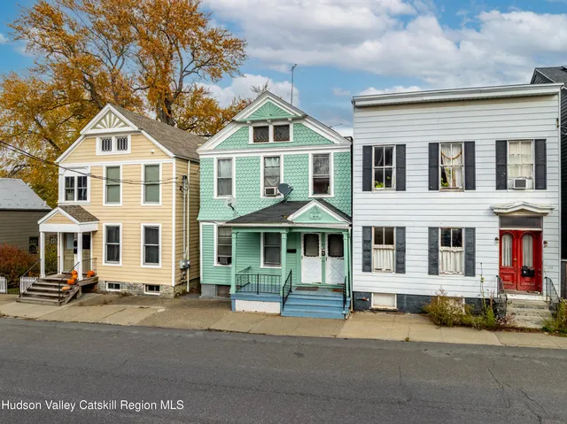 a front view of a residential apartment building with a yard