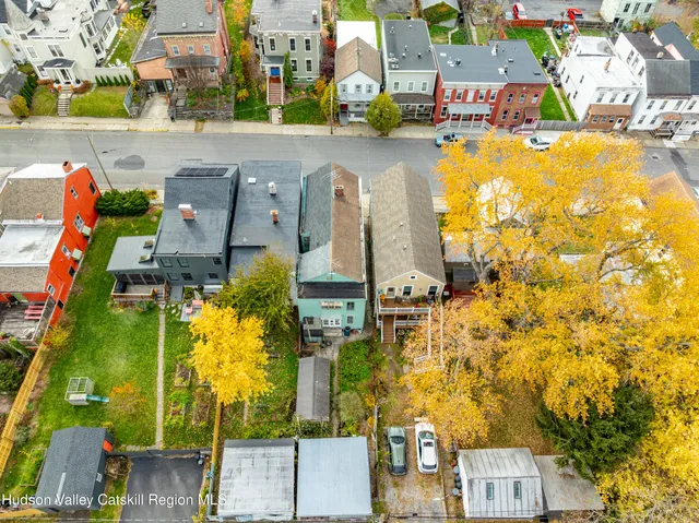 an aerial view of residential houses with outdoor space and swimming pool