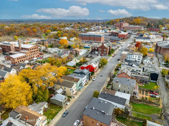 an aerial view of residential houses with city view