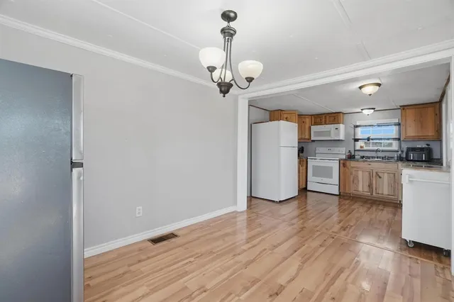 a view of a kitchen with a sink stainless steel appliances and cabinets