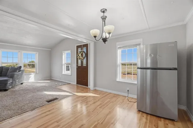 a view of a kitchen with a sink dishwasher refrigerator and wooden floor