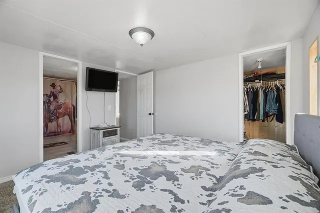 a bedroom with a bed and a television