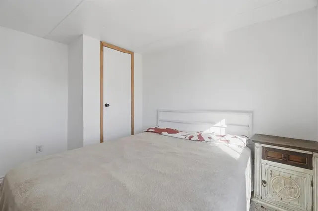 a bed room with a bed and a night stand