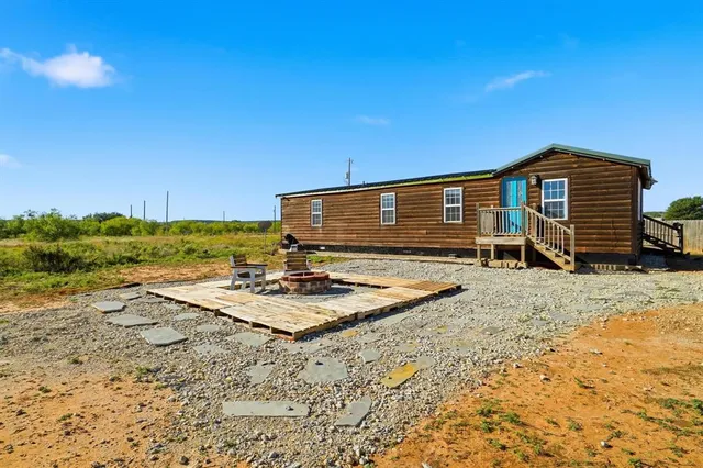 a view of a house with wooden fence