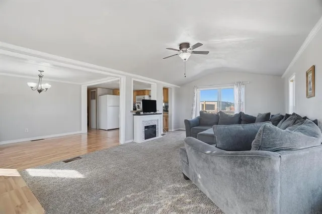 a living room with furniture and a kitchen