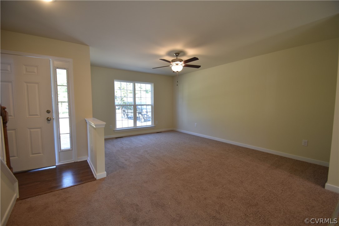2435 Meadow Road Sandston, VA 23150 - Photo 5 of 14 an empty room with windows and ceiling fan