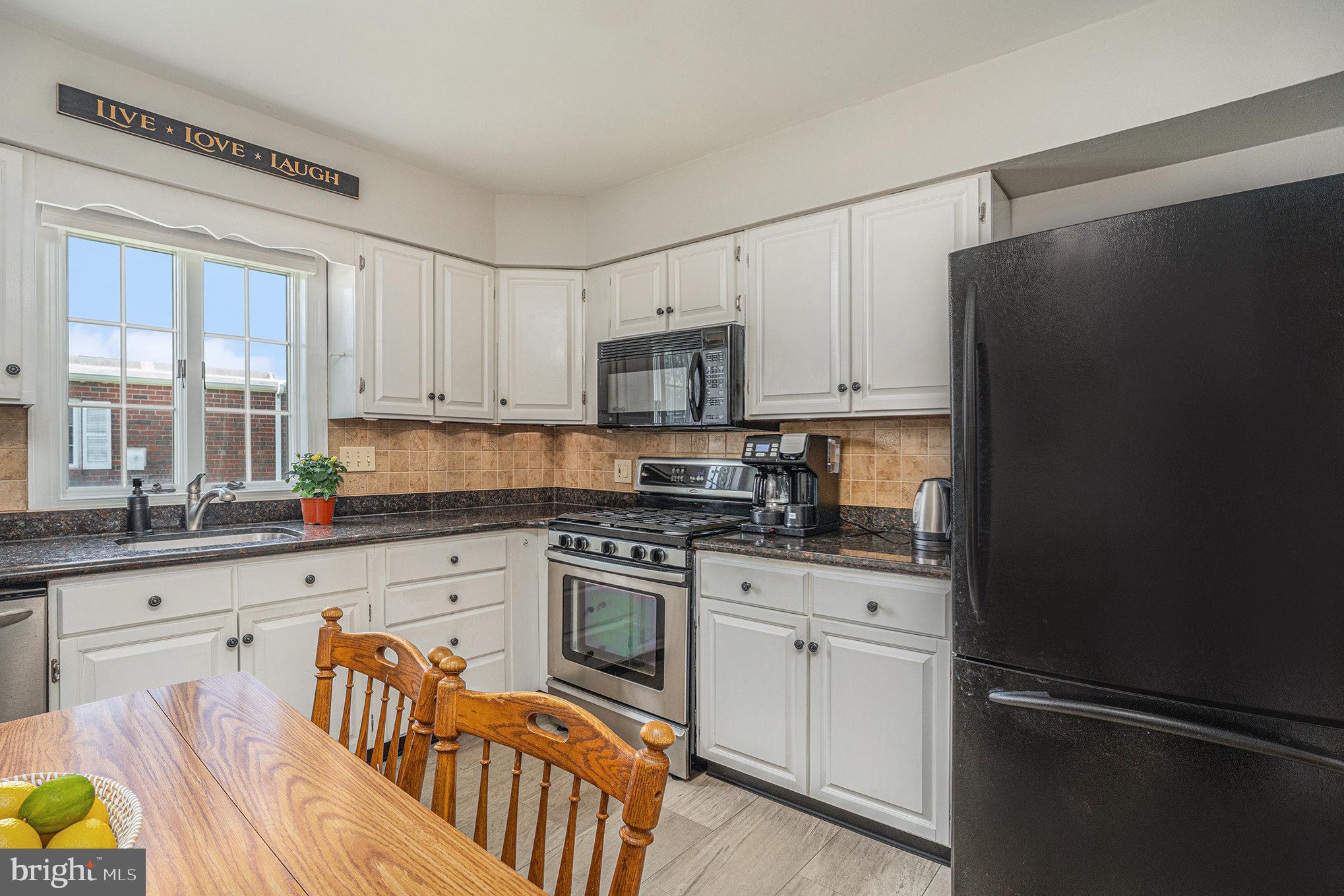 13027 Stevens Road Philadelphia, PA 19116 - Photo 16 of 39 a kitchen with stainless steel appliances granite countertop a refrigerator stove top oven and sink