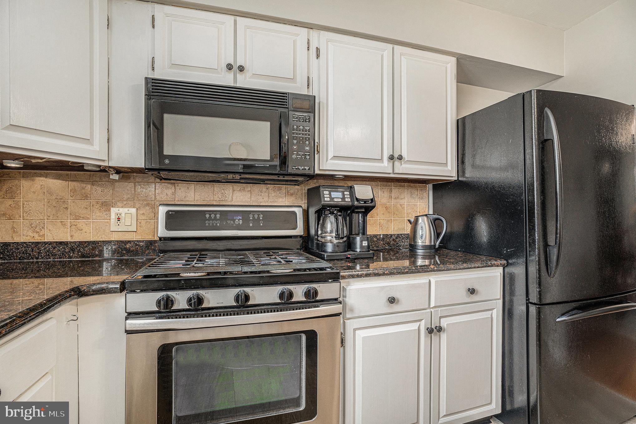 13027 Stevens Road Philadelphia, PA 19116 - Photo 18 of 39 a kitchen with stainless steel appliances granite countertop a stove a microwave and a refrigerator