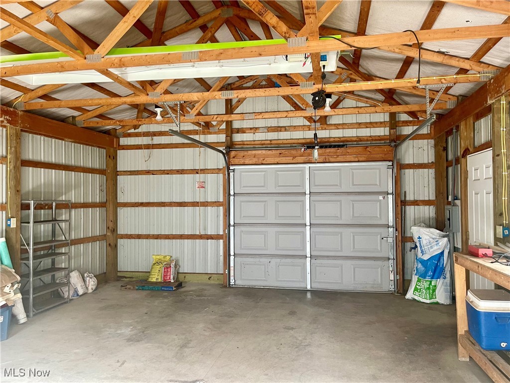 6518 Stonecreek Road Southwest Newcomerstown, OH 43832 - Photo 31 of 42 Garage with metal wall and a garage door.