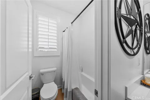 a white toilet sitting next to a bathroom sink