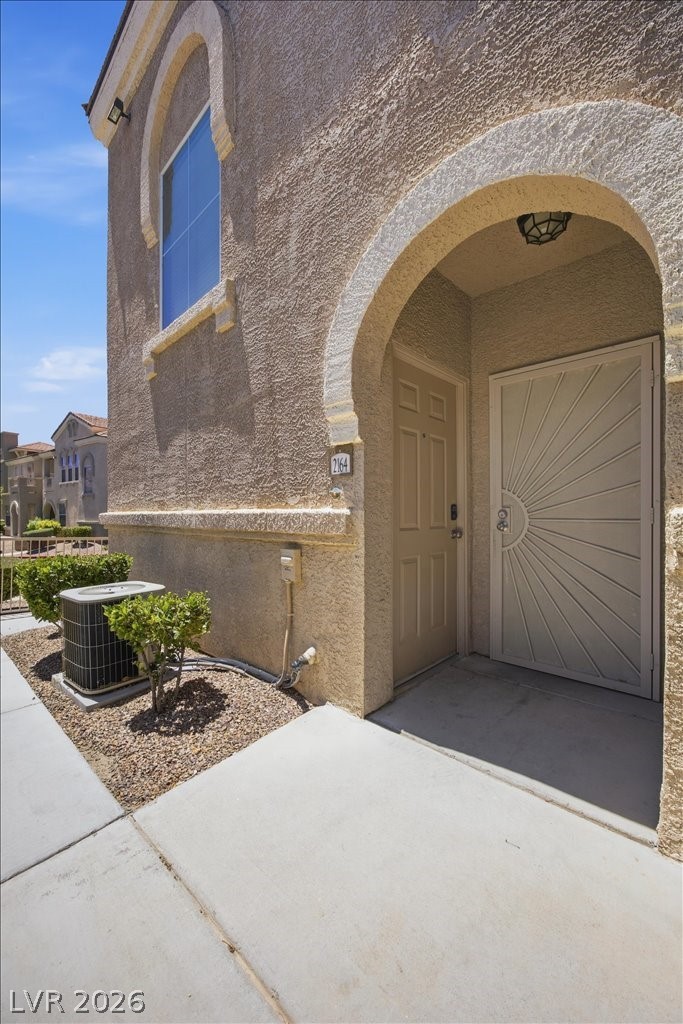 10550 West Alexander Road, Unit 2164 Las Vegas, NV 89129 - Photo 27 of 27 An inviting arched entryway welcomes you to this desert-hued residence.