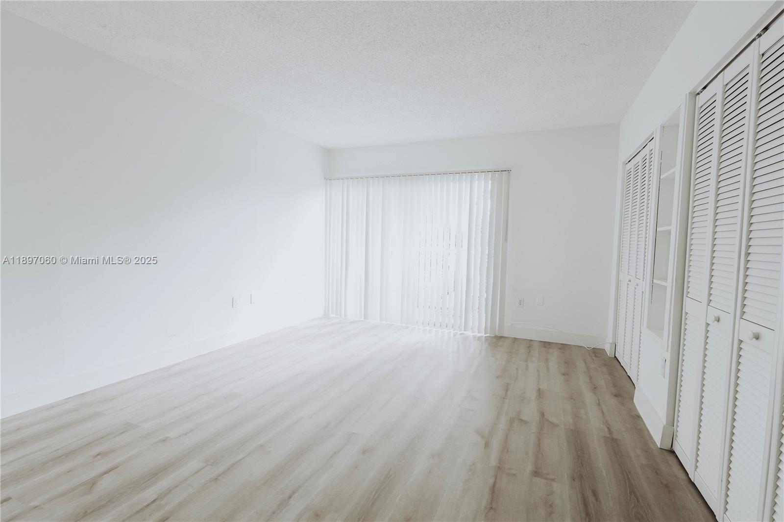 3791 Northwest 78th Avenue, Unit 24 Davie, FL 33024 - Photo 13 of 22 a view of an empty room and wooden floor
