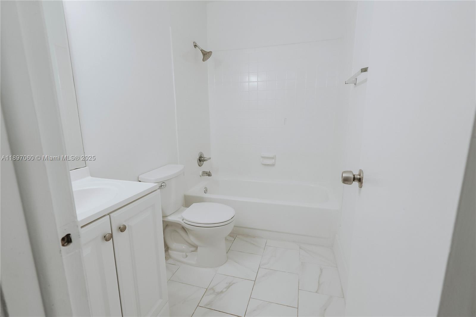 3791 Northwest 78th Avenue, Unit 24 Davie, FL 33024 - Photo 14 of 22 a bathroom with a white toilet and a shower