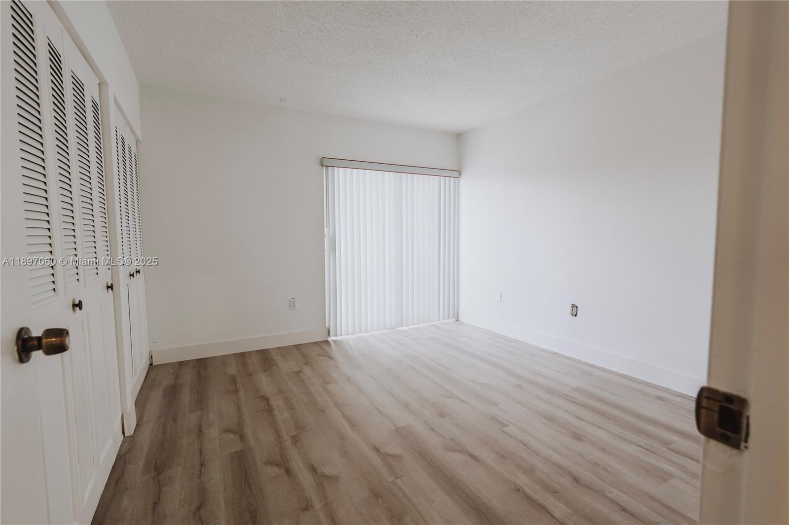 3791 Northwest 78th Avenue, Unit 24 Davie, FL 33024 - Photo 15 of 22 a view of a room with wooden floor and white walls