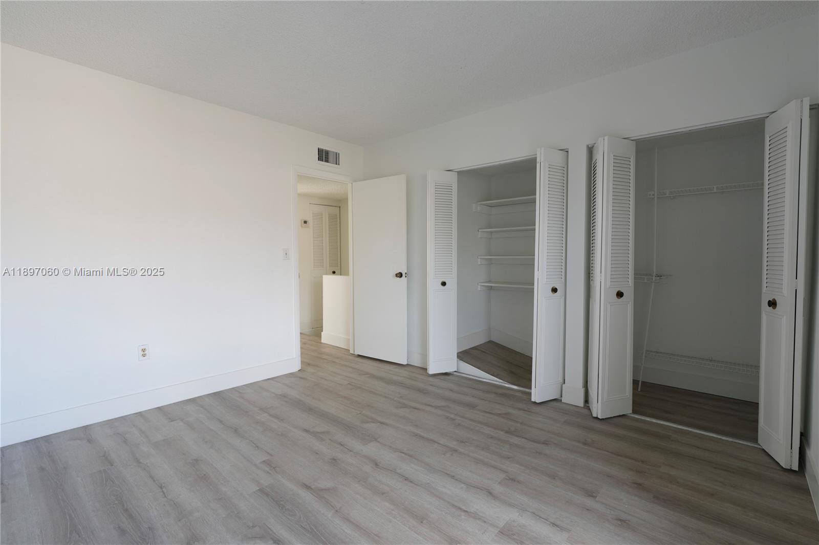 3791 Northwest 78th Avenue, Unit 24 Davie, FL 33024 - Photo 17 of 22 a view of an empty room with wooden floor