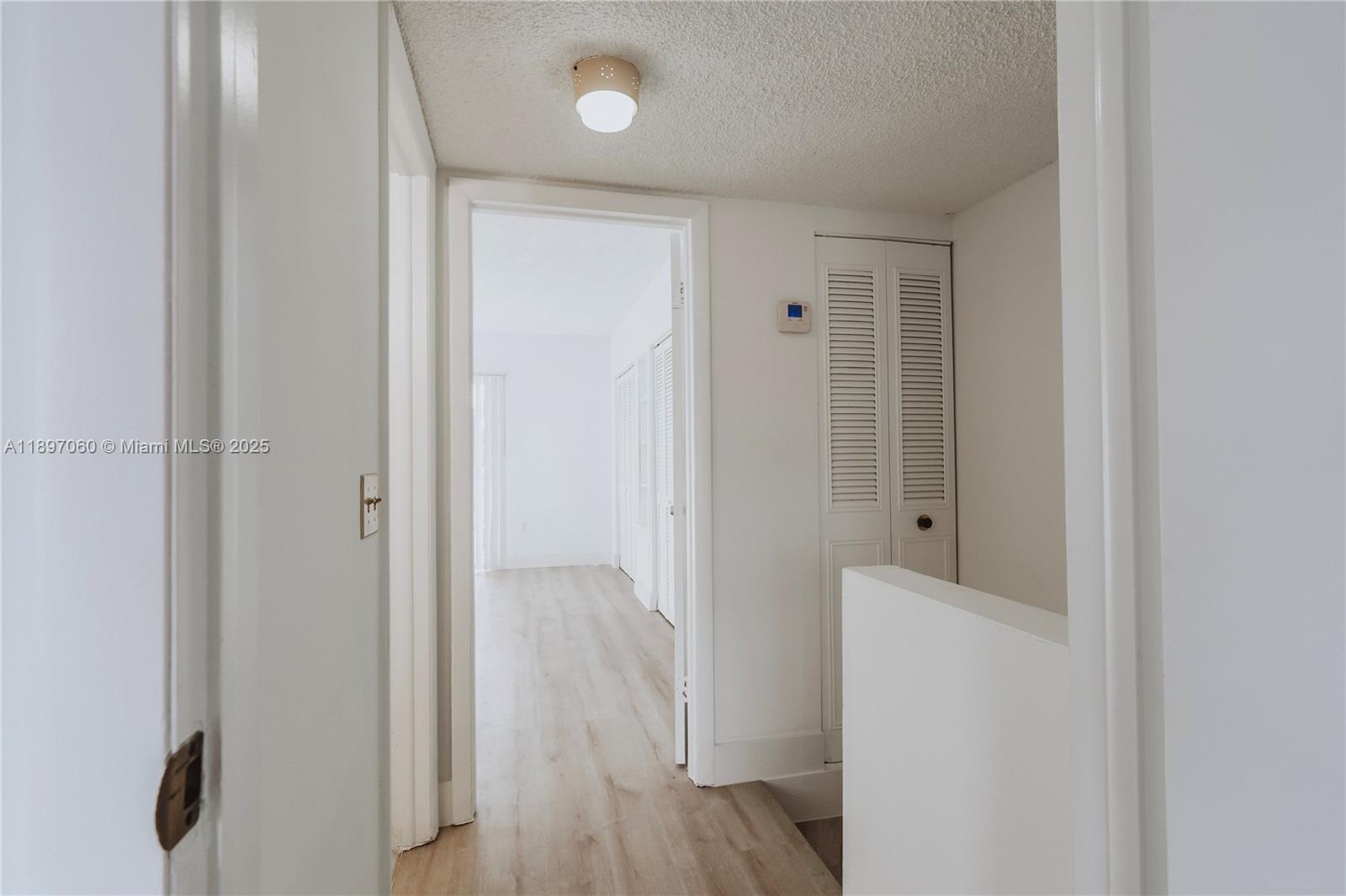 3791 Northwest 78th Avenue, Unit 24 Davie, FL 33024 - Photo 18 of 22 a view of a hallway with wooden floor