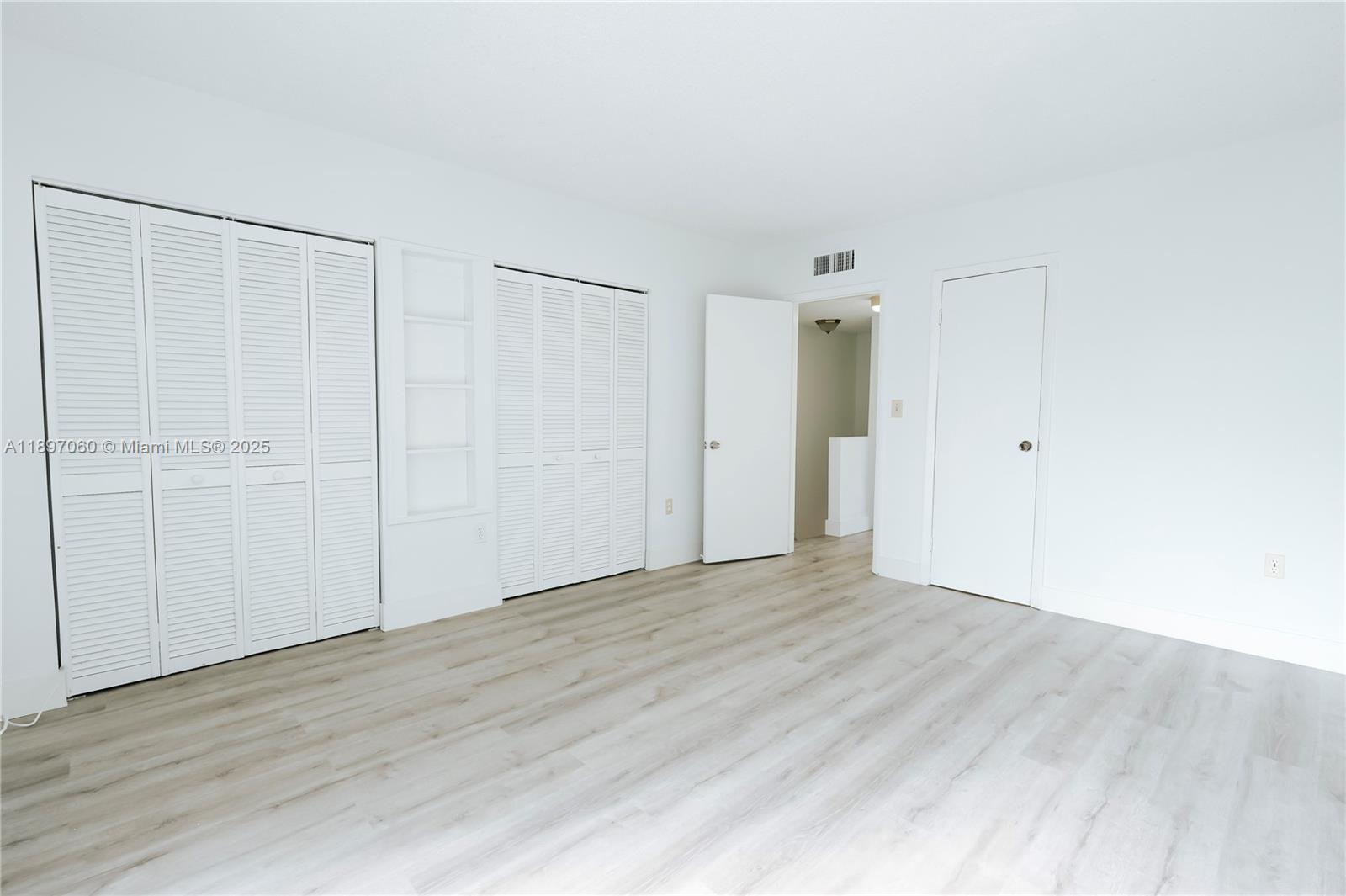 3791 Northwest 78th Avenue, Unit 24 Davie, FL 33024 - Photo 20 of 22 a view of an empty room with wooden floor