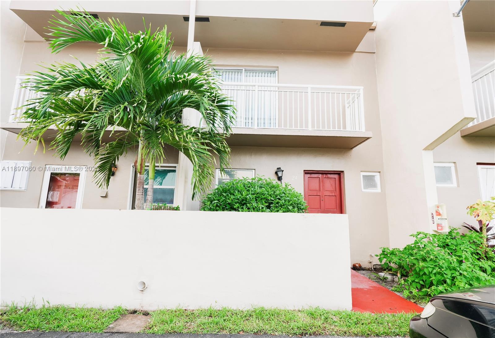 3791 Northwest 78th Avenue, Unit 24 Davie, FL 33024 - Photo 2 of 22 a view of front door of house with potted plants