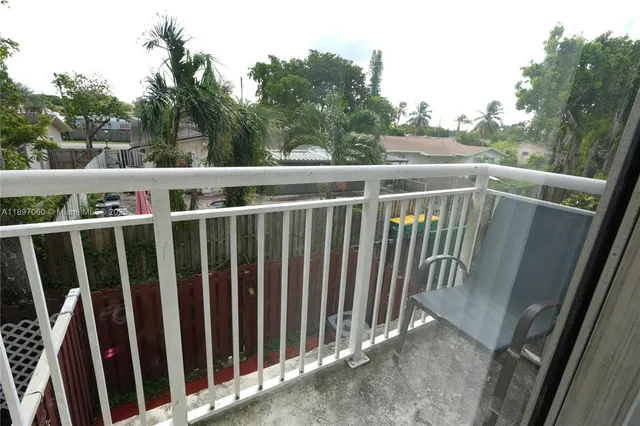 a view of a balcony with wooden fence and floor