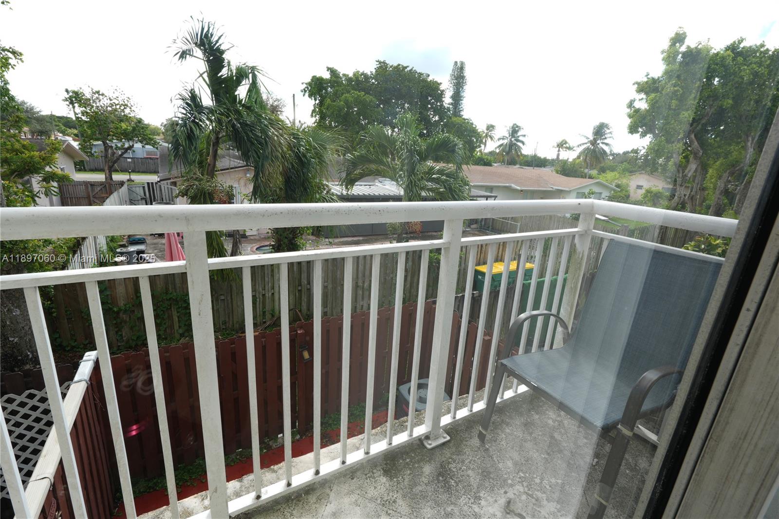 3791 Northwest 78th Avenue, Unit 24 Davie, FL 33024 - Photo 21 of 22 a view of a balcony with wooden fence and floor