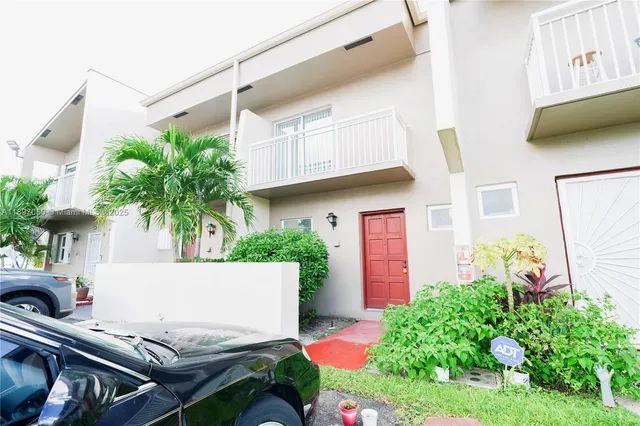 a view of a backyard with plants and a patio